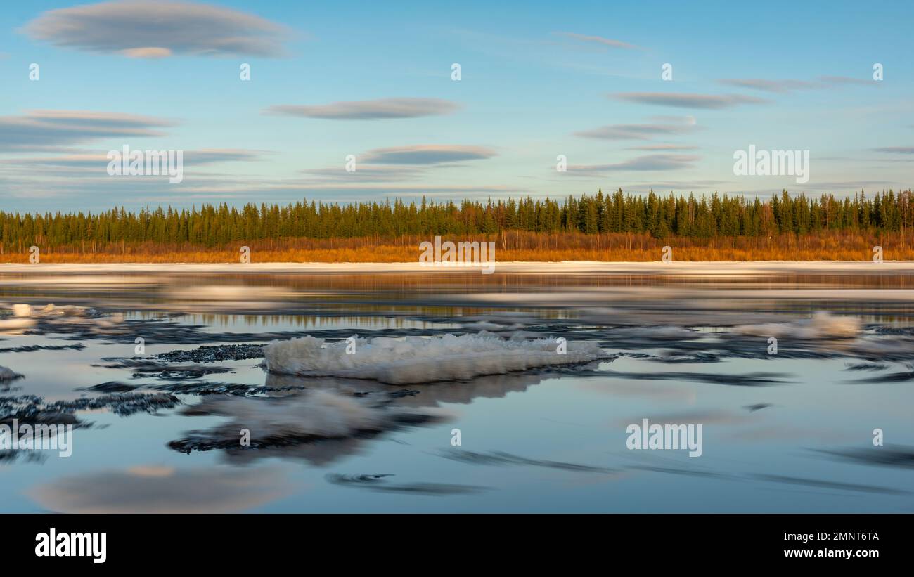 The remains of the last spring ice on the Vilyui River in Yakutia float in the water. Ice drift. Stock Photo