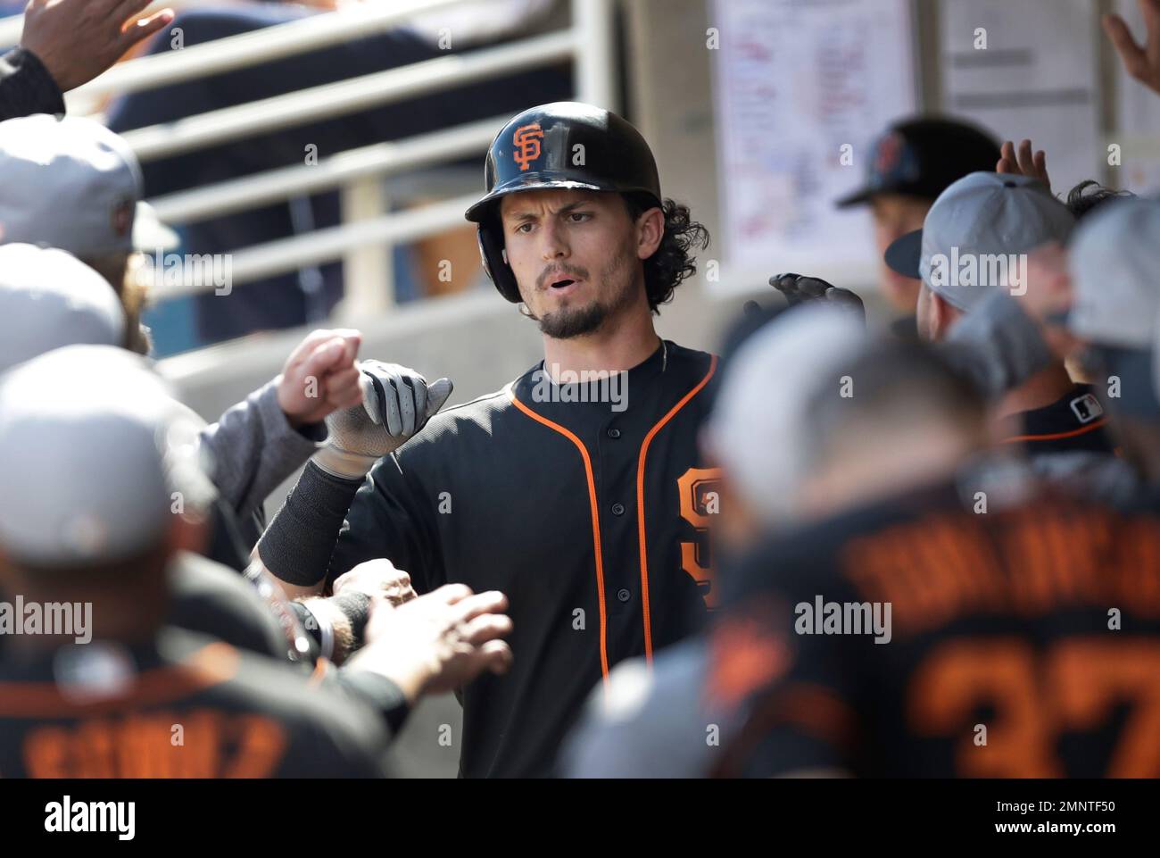 San Francisco Giants' Jarrett Parker is greeted in the dugout after his  solo home run during the fourth inning of a spring training baseball game  against the Milwaukee Brewers, Wednesday, Feb. 28,