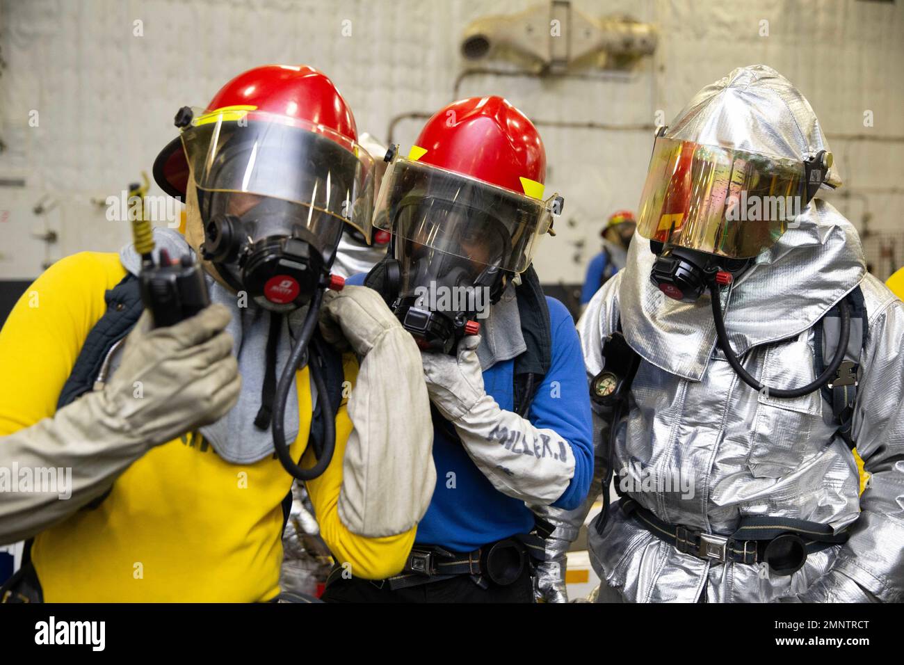 Aviation Boatswain's Mate (Handling) Airman Justin Miller, center, from