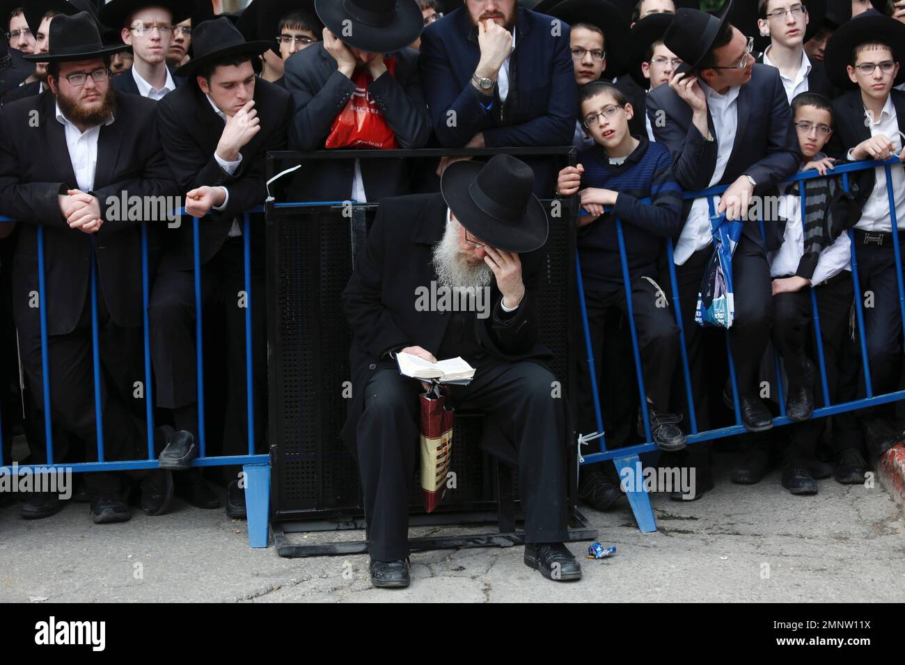 Ultra orthodox Jewish men gather during the funeral of Rabbi Shmuel
