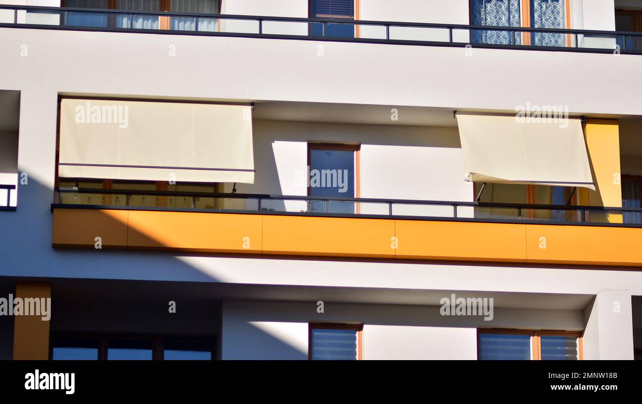 Modern architecture building facade with awnings. Balcony with awning
