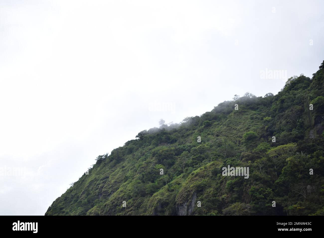 Indonesian Landscape. White clouds in the mountainous area. The mountainous location called 'Bulu Dua' Photo during the day Stock Photo