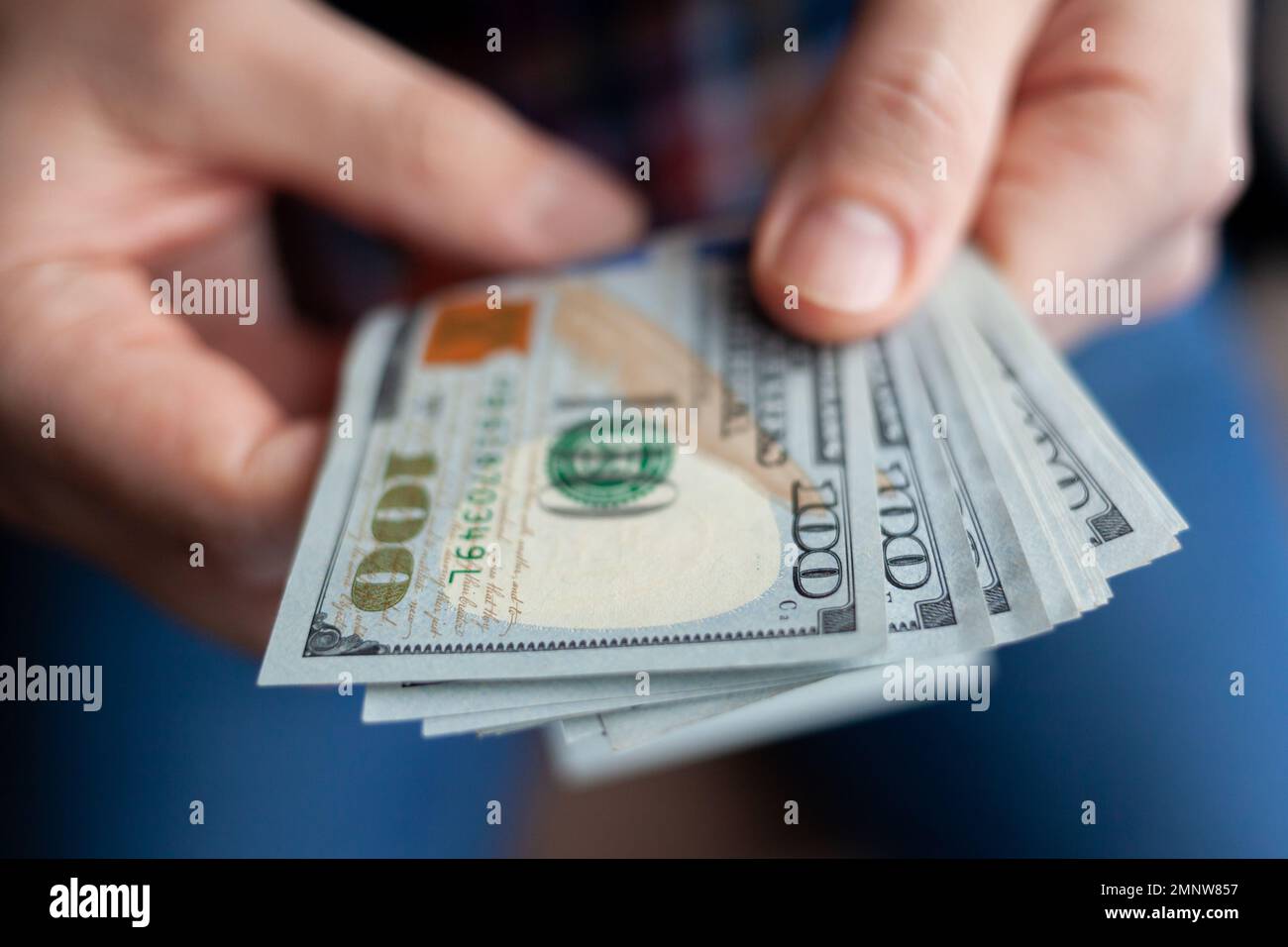 Close up male hand Counting and holding money us dollar. The concept of financial business and crisis. Stock Photo