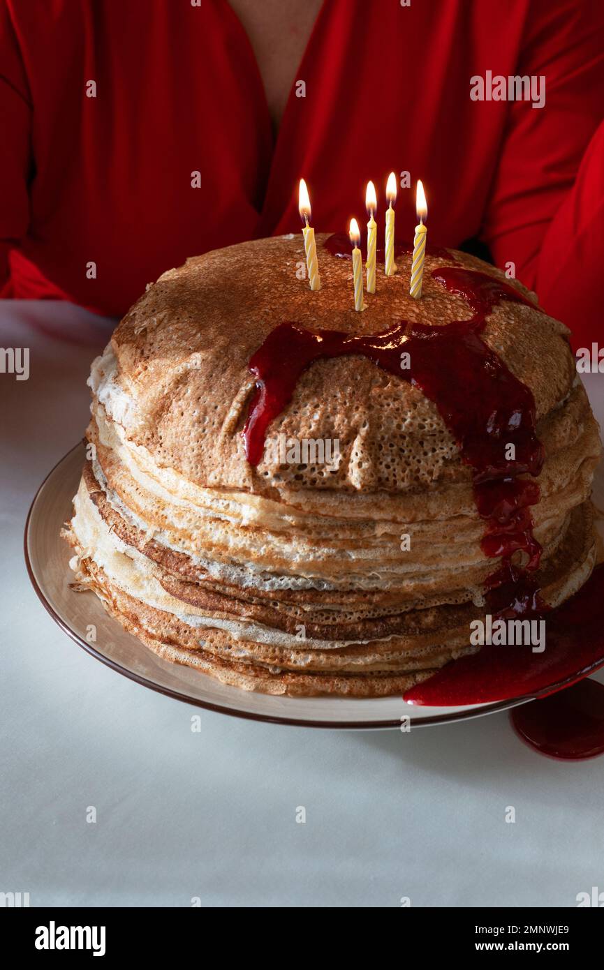 Pancakes with berries jam and 5 candles Stock Photo