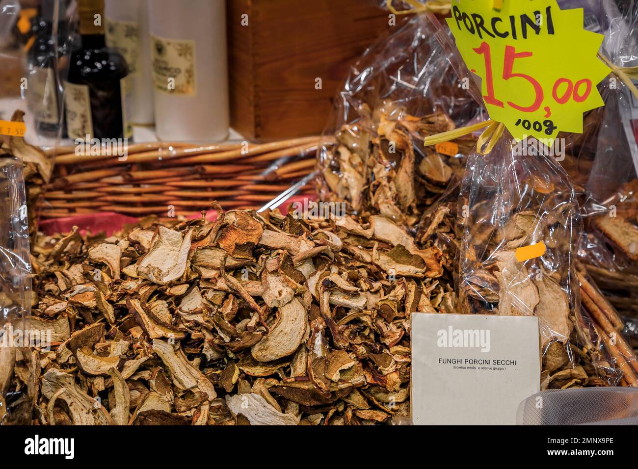 Dried sliced porcini mushrooms for sale in a wicker basket with a description label at a shop in Central Market Mercato Centrale in Florence, Italy Stock Photo