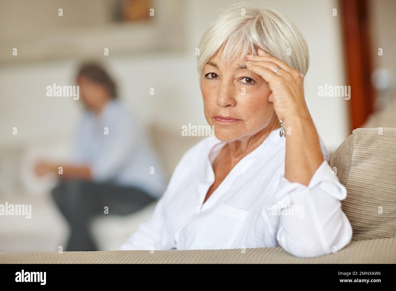 Aging is not for sissies. a senior woman looking sad while sitting on the sofa at home. Stock Photo