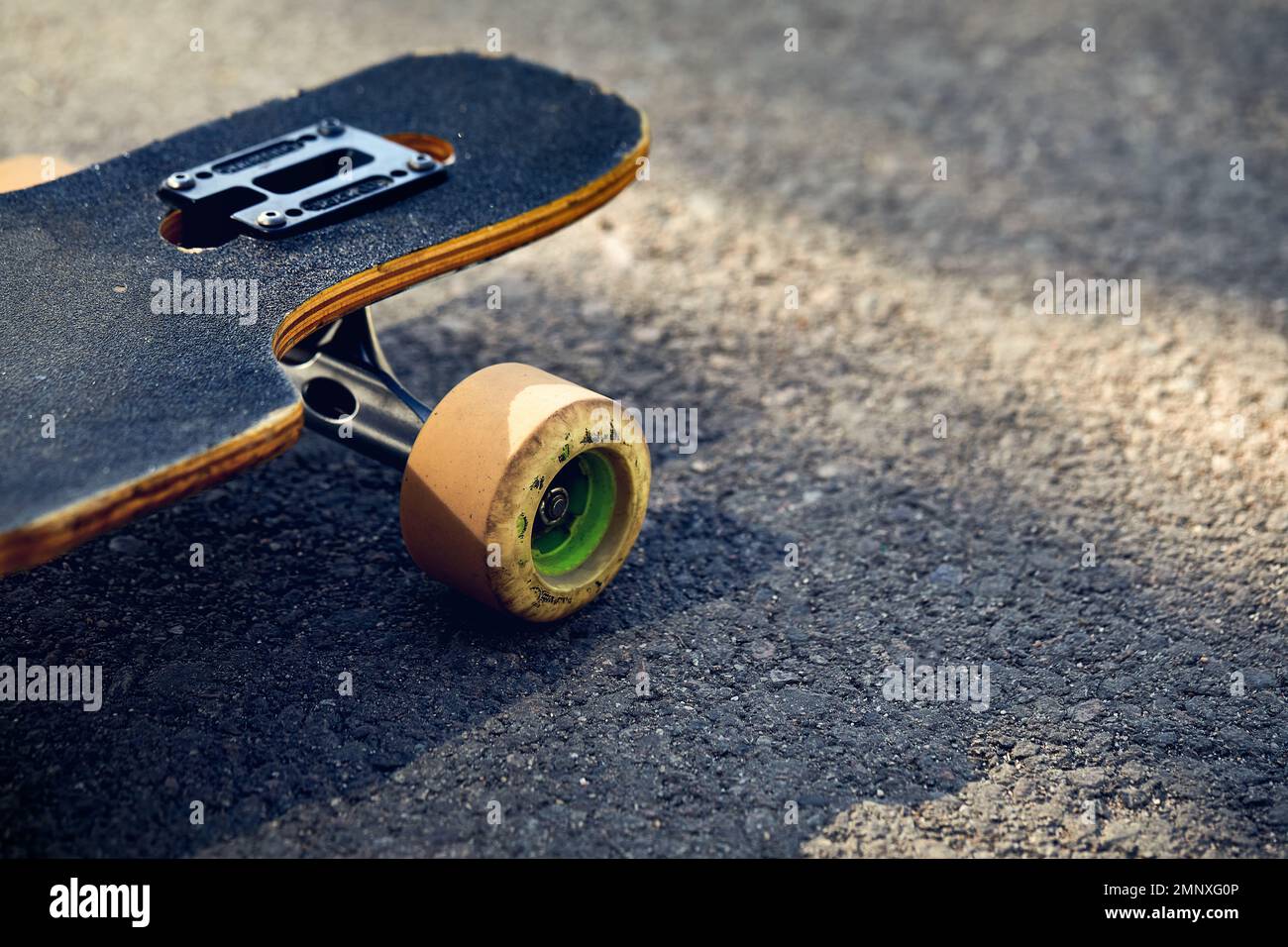 Skate board longboard at mountain asphalt road close up shot at of tail with wheels detail Stock Photo
