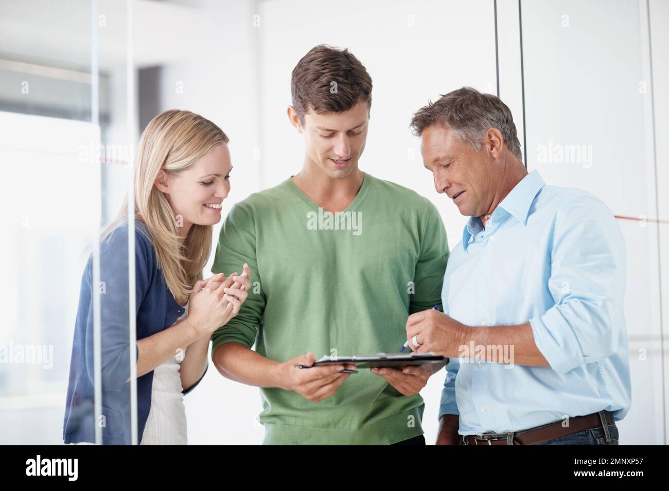 Doing some brainstorming. Three work colleagues discussing something work related. Stock Photo