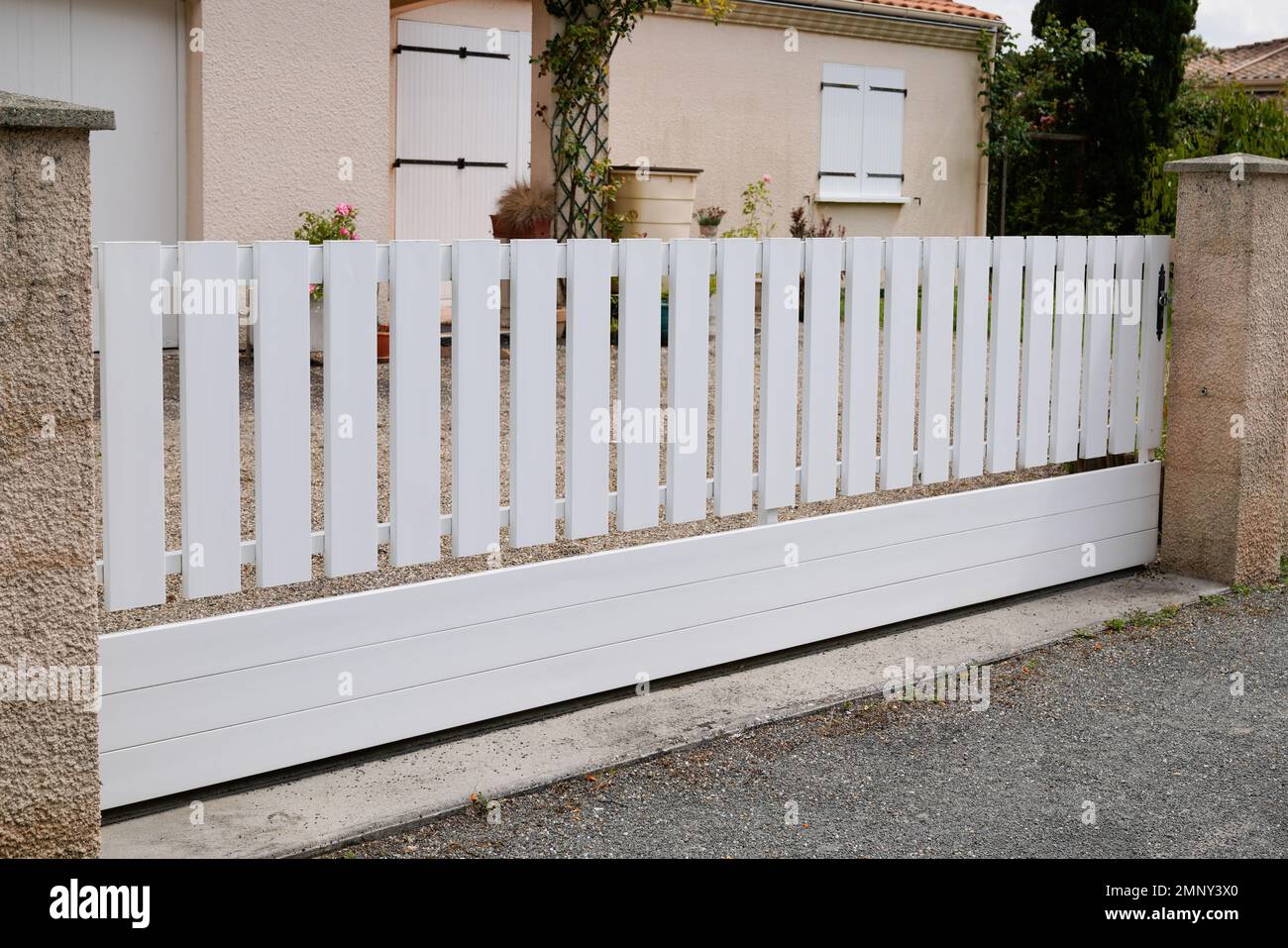 white classic sliding home door aluminum gate slide portal of suburb house Stock Photo