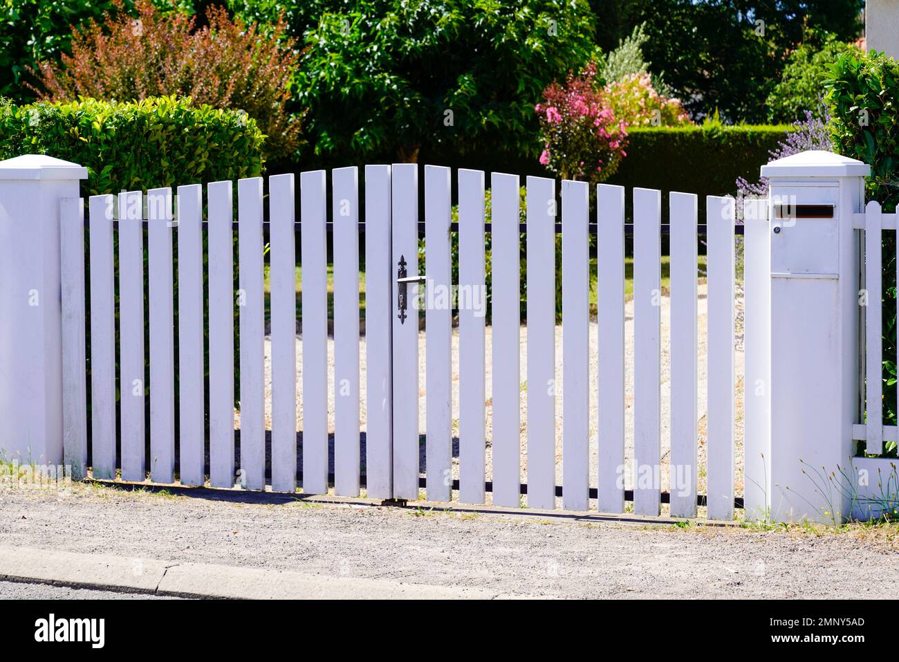 classic white gate aluminum portal with blades plank design of suburban house Stock Photo