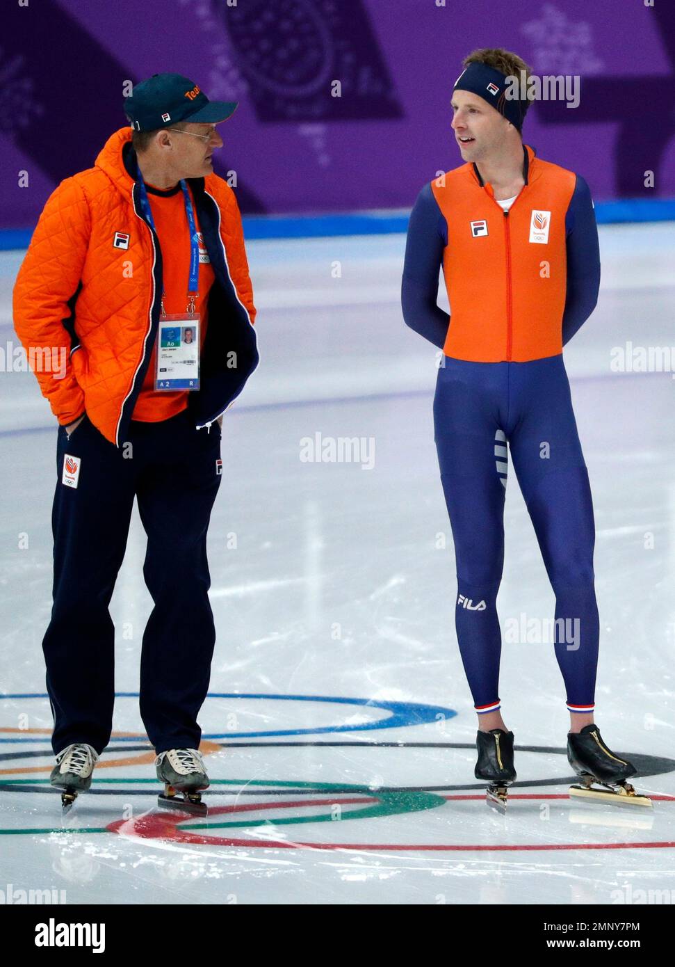 Bob de Vries of The Netherlands, right, talks to coach Jillert Anema, left,  of The Netherlands during the official training session for the men's 5,000  meters race at the Gangneung Oval at