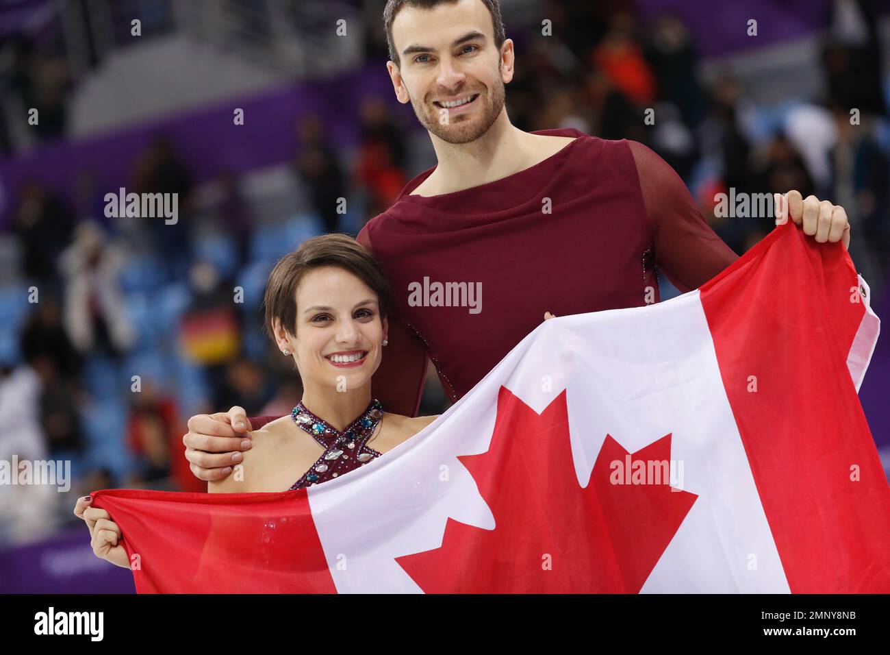 Meagan Duhamel and Eric Radford of Canada celebrate after taking the