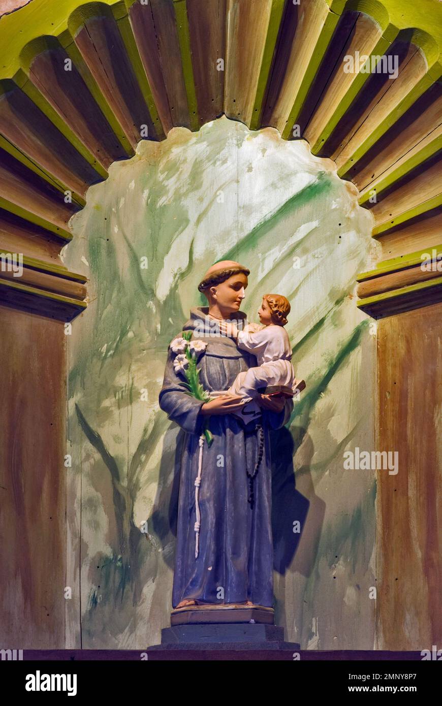 Statue of St Anthony holding Baby Jesus, at main altar at church, La Purisima Mission State Park near Lompoc, California, USA Stock Photo