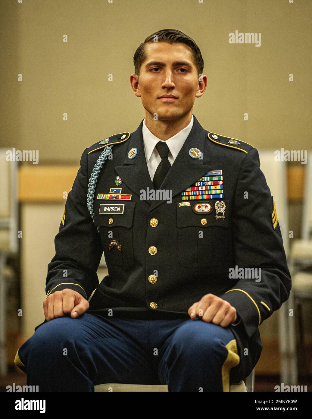 Special forces sergeant, battle squad leader in camo uniform, helmet with  radio headset, armed rifle standing on knee, pointing direction, giving  orders to teammates studio shoot isolated on white Stock Photo -