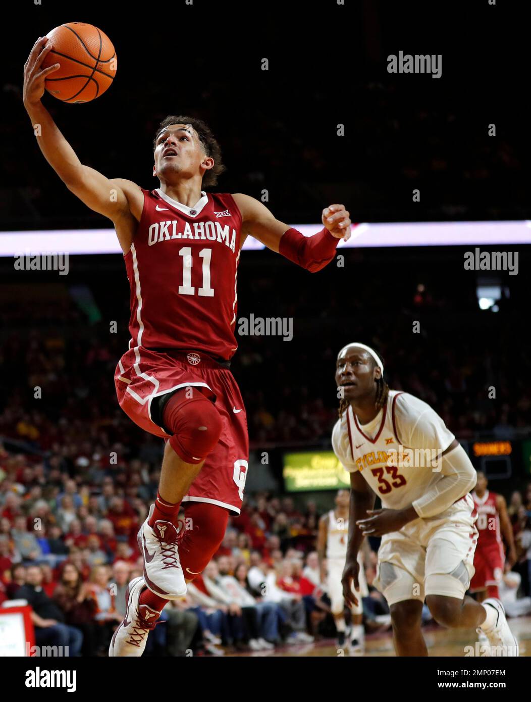 Oklahoma guard Trae Young (11) dries to the basket over Iowa State