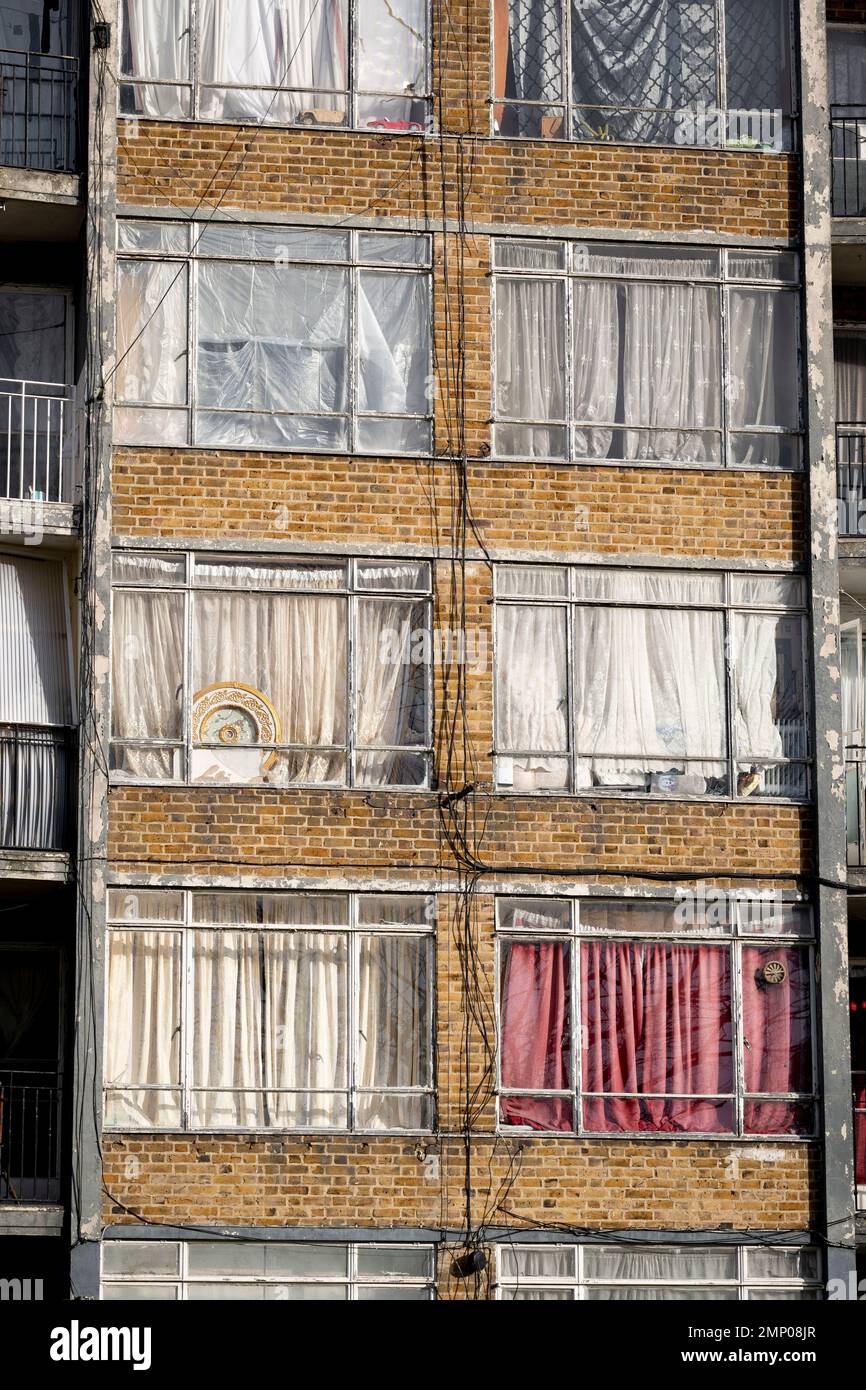 Dirty windows and closed curtains obscure the interiors of rented flats