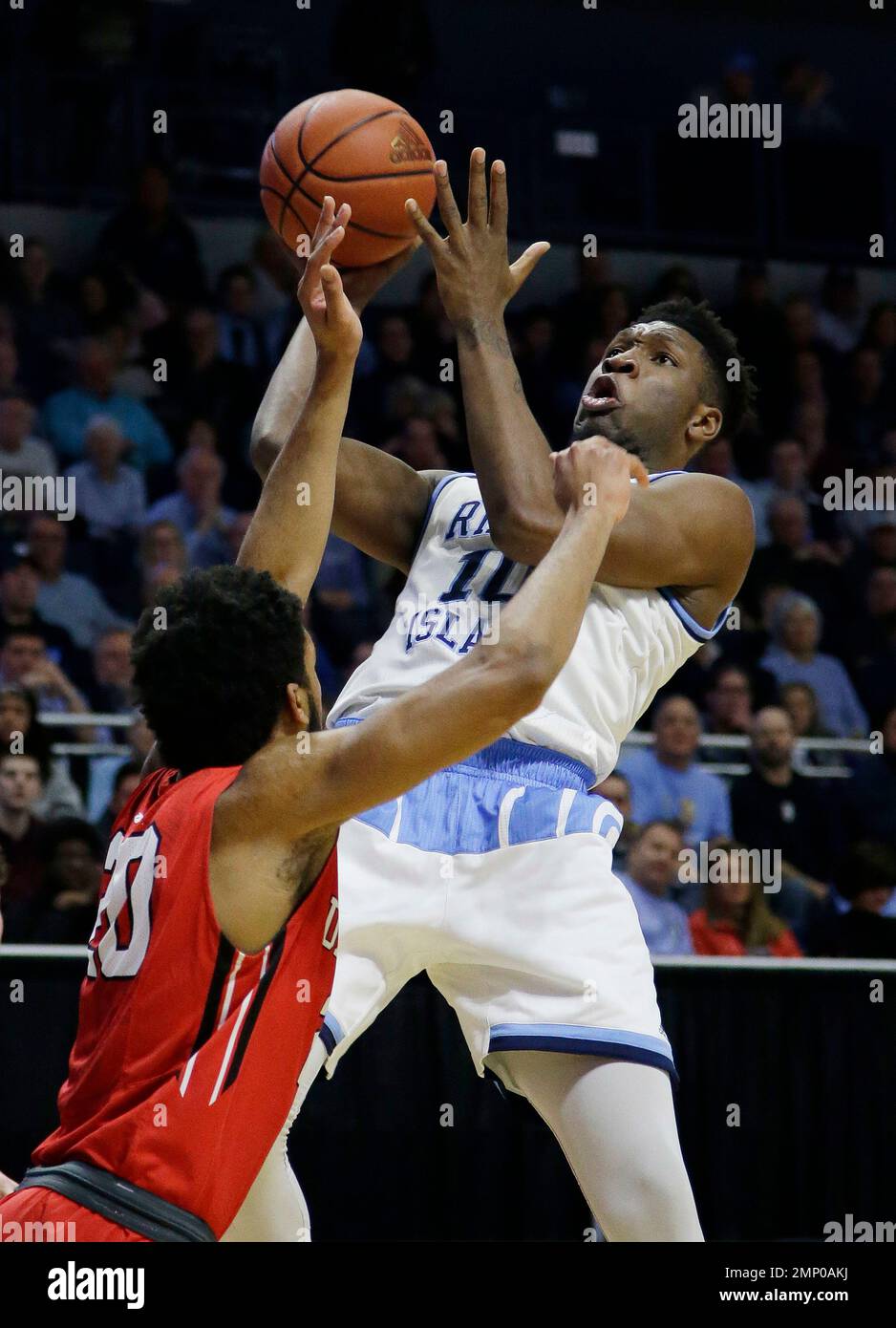 Rhode Island guard Jeff Dowtin (11) shoots over the defensive play of