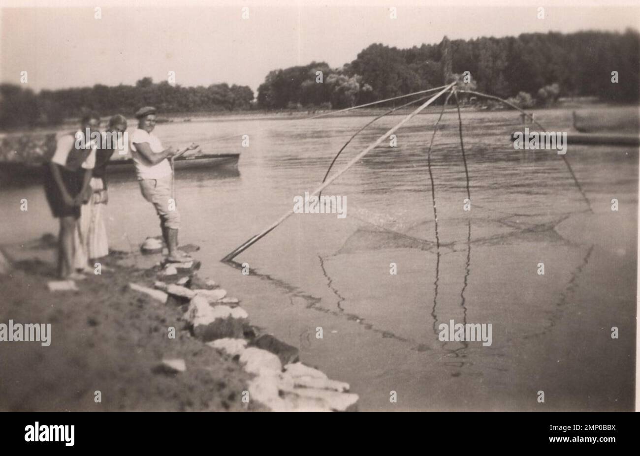 Vintage fishermen are in action hi-res stock photography and