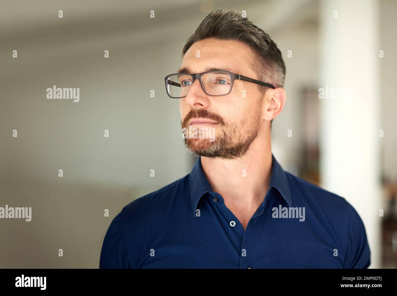 Doing some reflecting. a man standing in his home looking thoughtful. Stock Photo