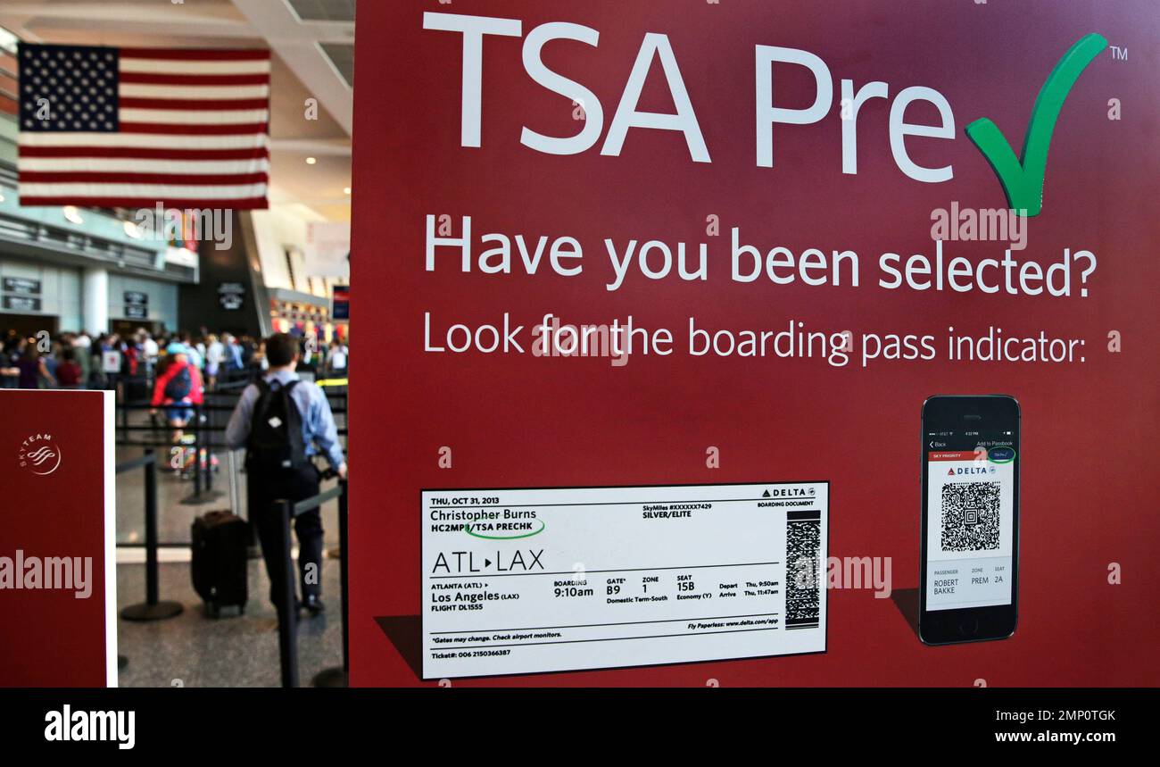 Travelers pass a sign for the Transportation Security Administration's