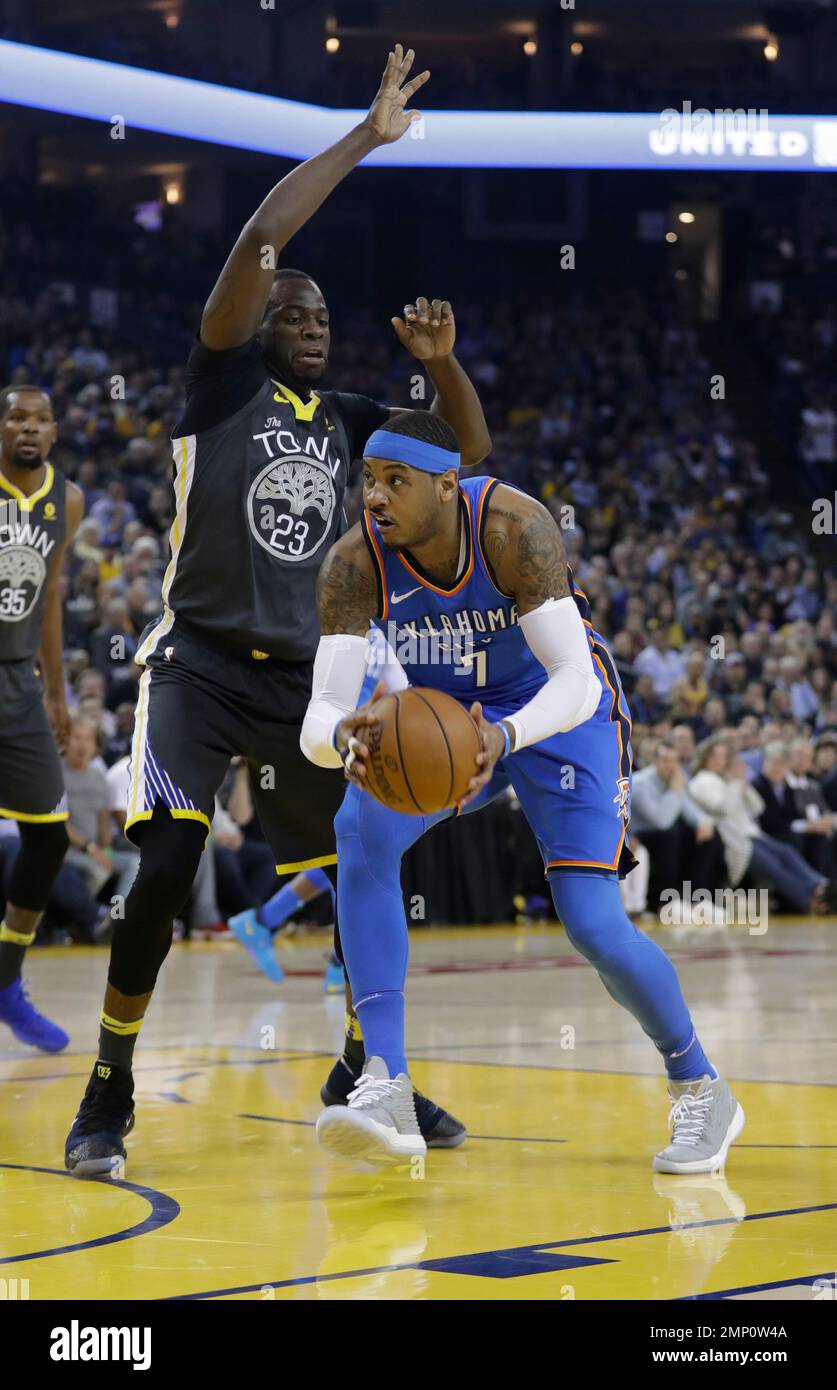 Oklahoma City Thunder's Carmelo Anthony, right, is defended by Golden State  Warriors' Draymond Green during the first half of an NBA basketball game  Tuesday, Feb. 6, 2018, in Oakland, Calif. (AP Photo/Marcio