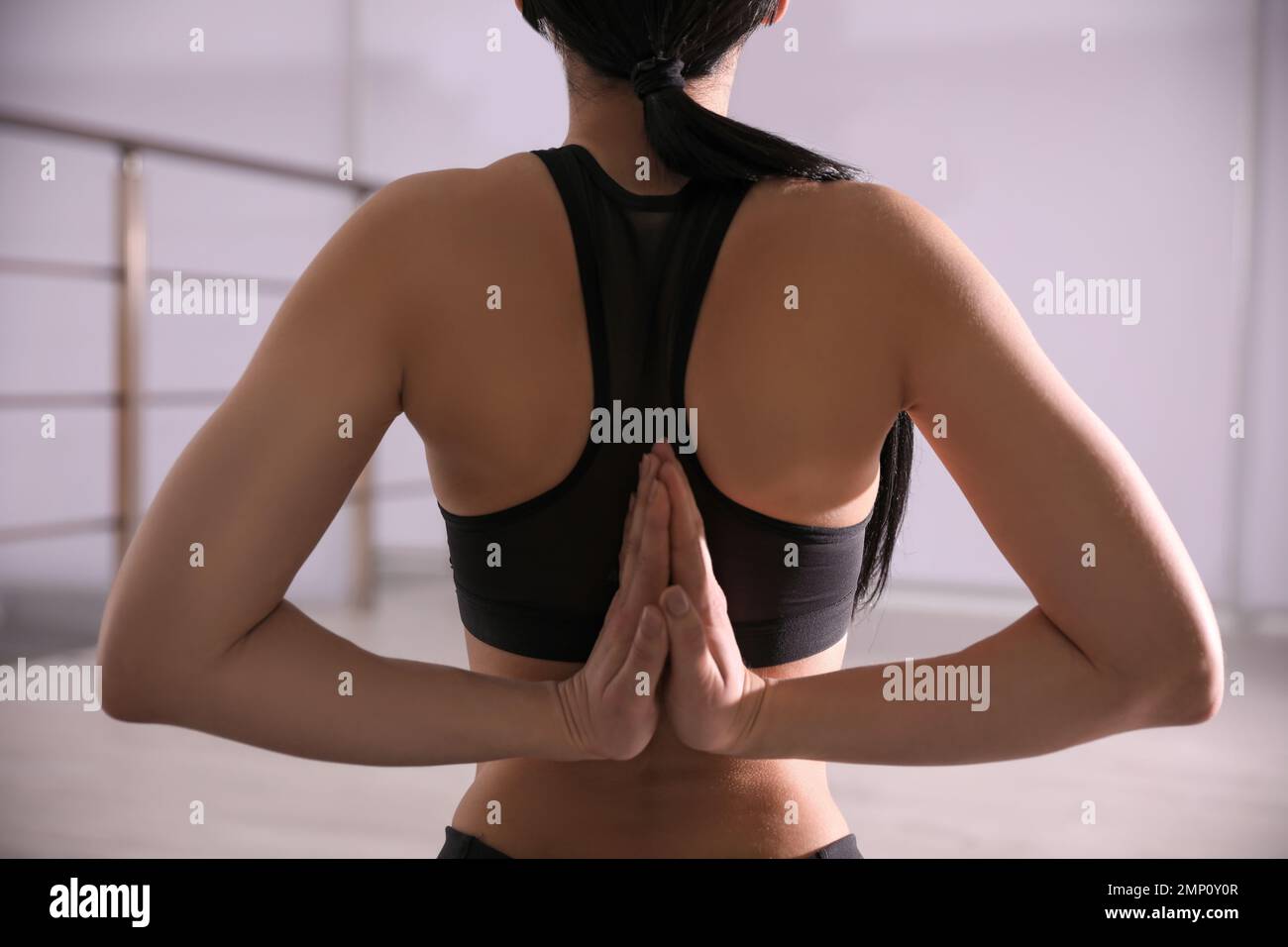 Young woman practicing seiza asana in yoga studio, closeup. Vajrasana pose Stock Photo