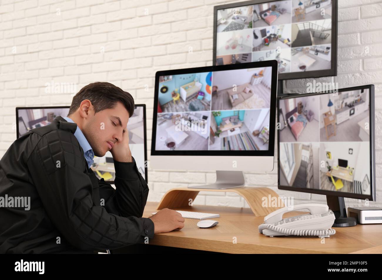 Male security guard sleeping near monitors at workplace Stock Photo Alamy