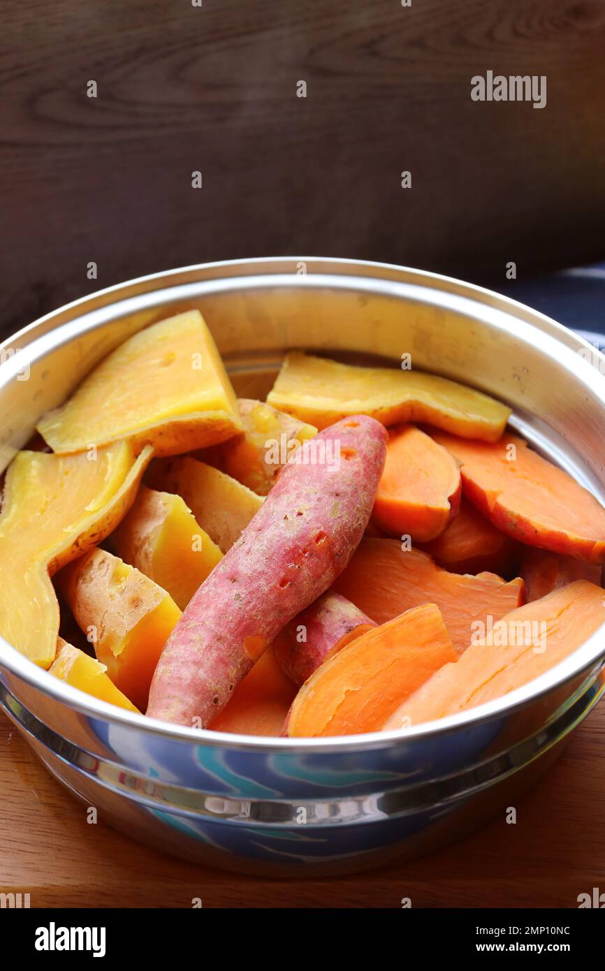 Pile of Steamed Tricolor Sweet Potatoes in a Steaming Pot Stock Photo