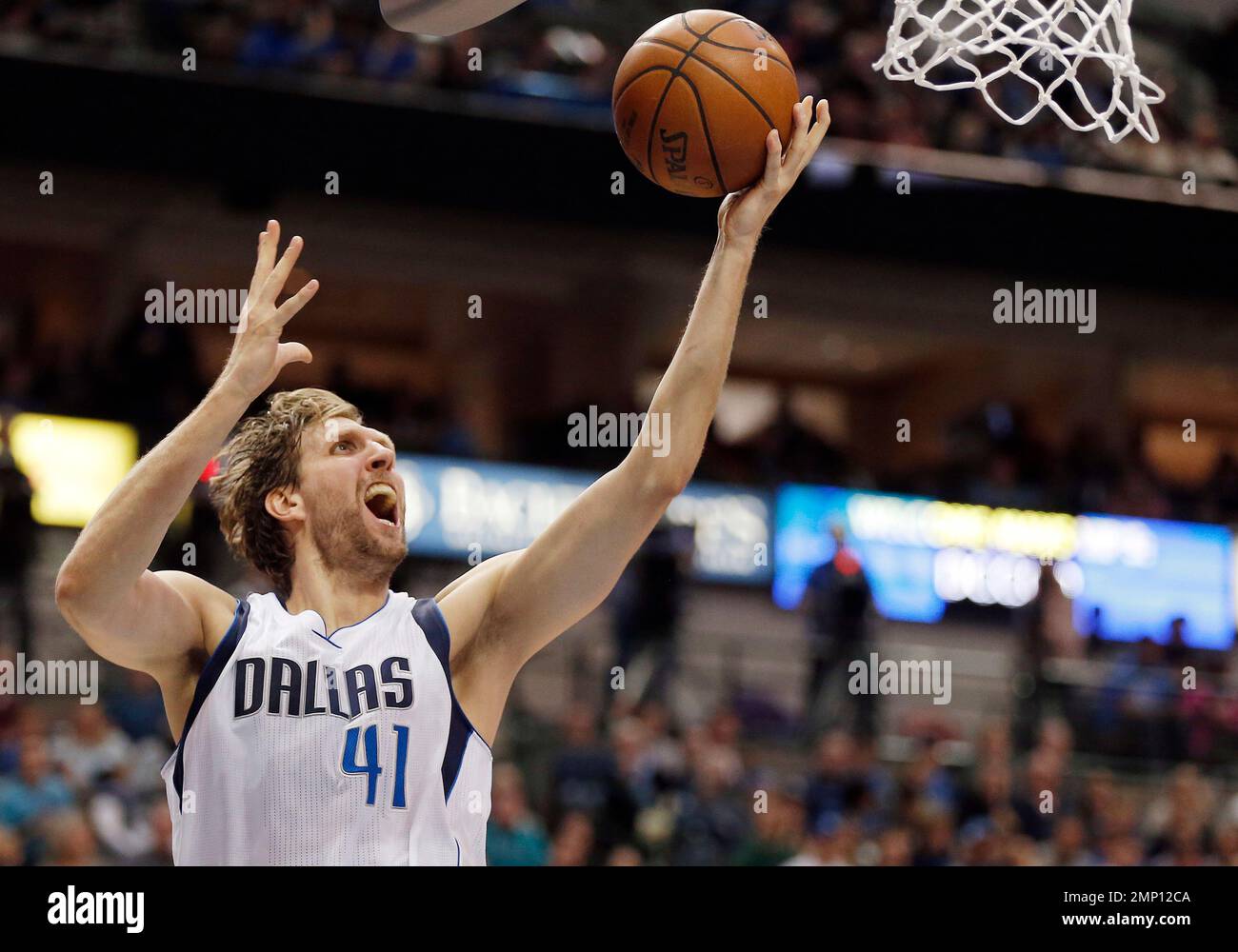 FILE - In this March 20, 2016, file photo, Dallas Mavericks Dirk Nowitzki (41) attempts a layup during the second half of an NBA basketball game against the Portland Trail Blazers