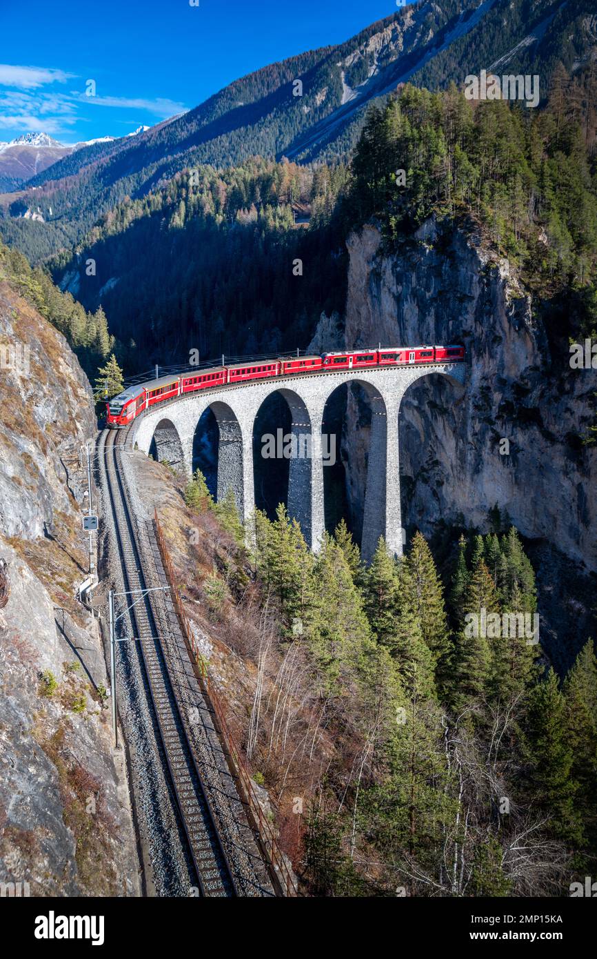 A train going through a tunnel onto a bridge.in the mountains Landwasser viaduct Stock Photo