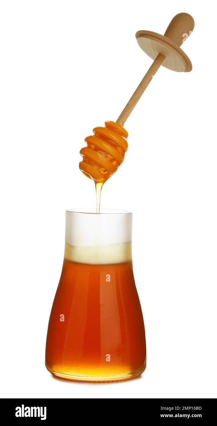 Honey dripping from dipper into jar isolated on white Stock Photo - Alamy
