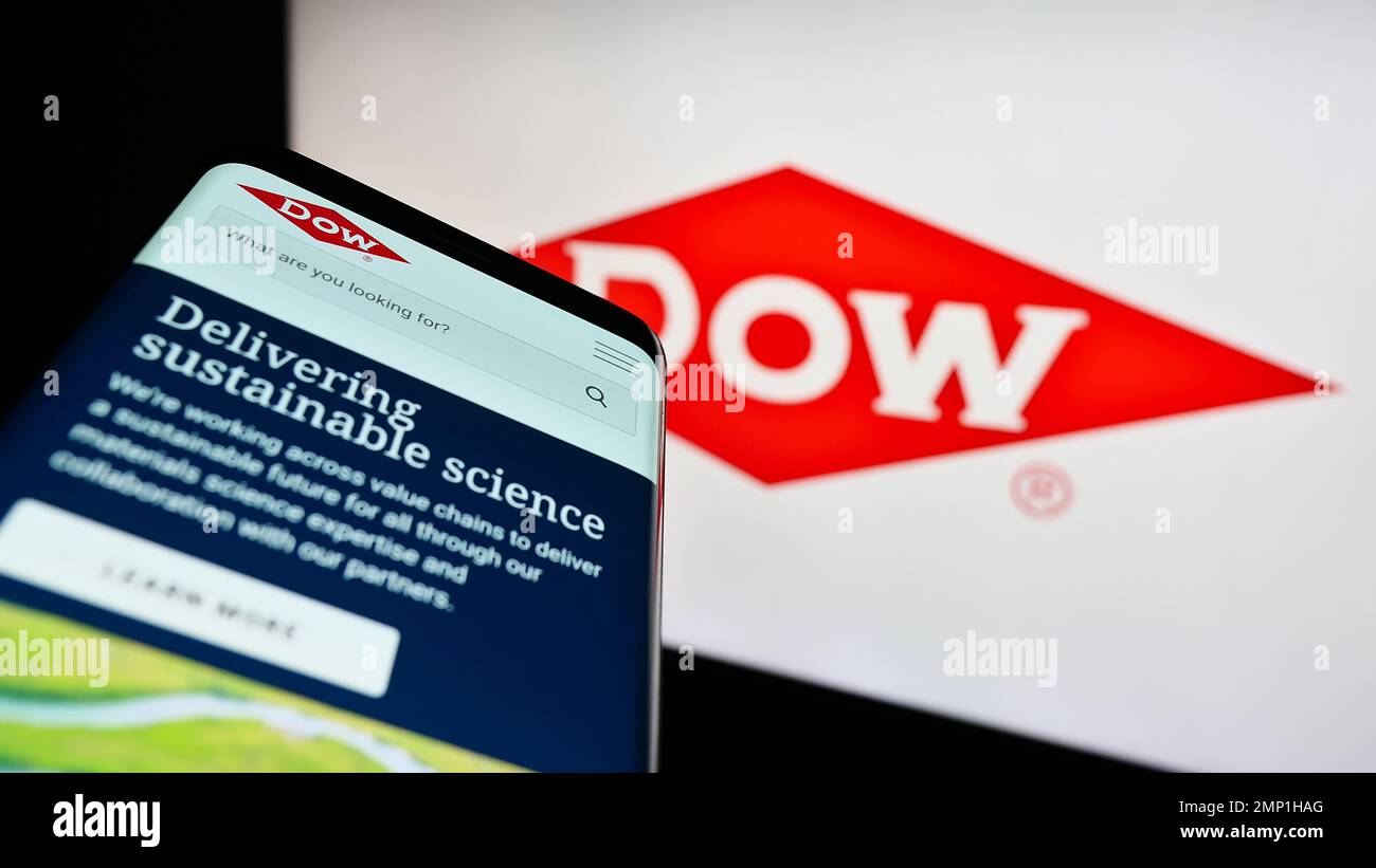Smartphone with website of US chemical company Dow Inc. on screen in front of business logo. Focus on center of phone display. Stock Photo
