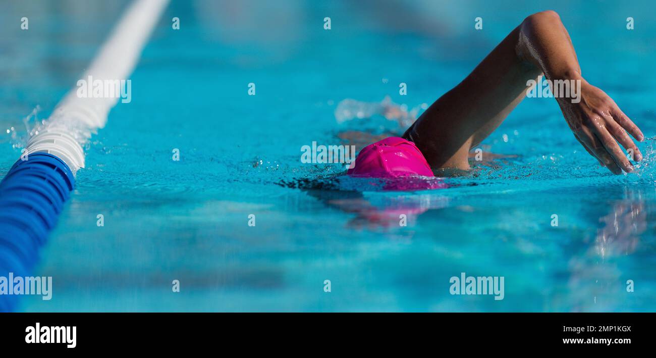 Swim competition swimmer athlete doing crawl stroke in swimming pool