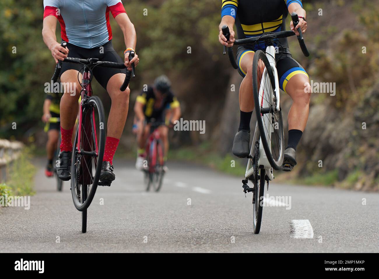 Cyclists riding on the rear wheel at the race. Balancing while driving