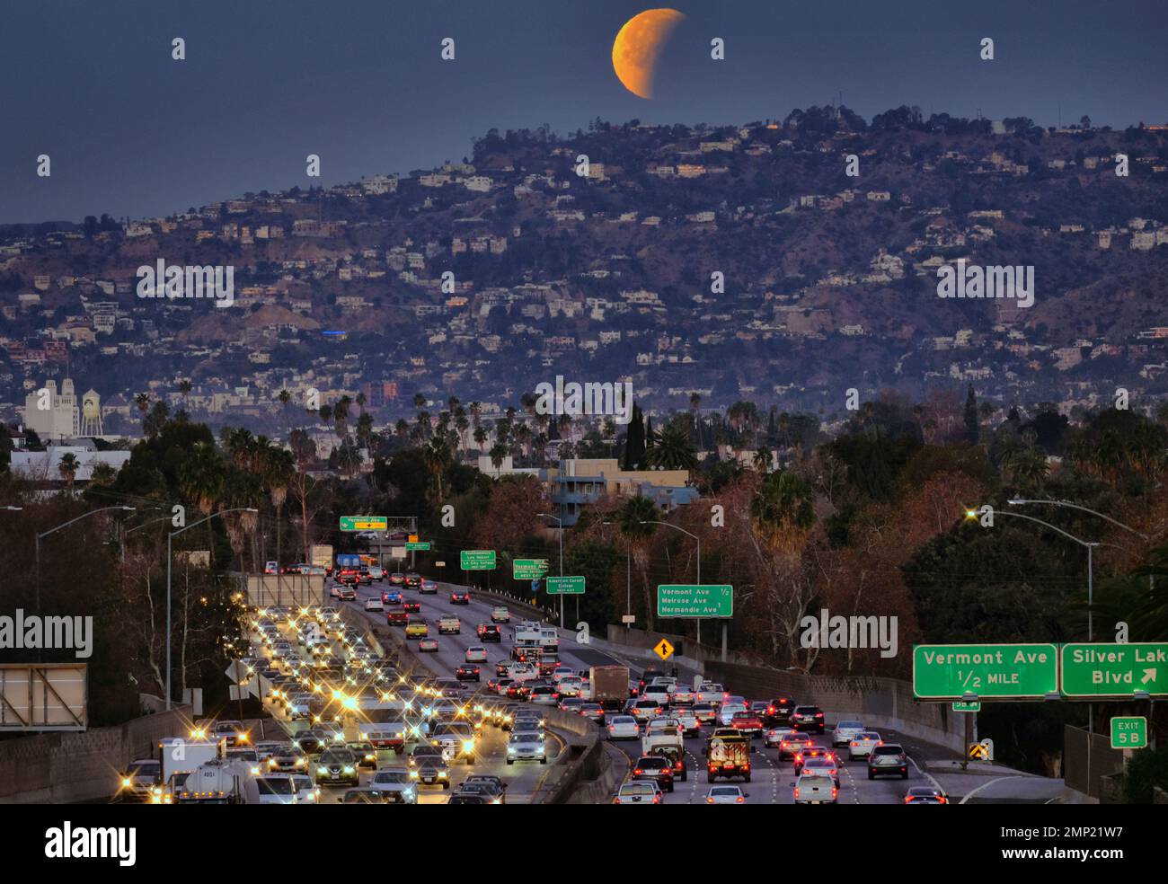 A super blue blood moon is seen setting behind the Hollywood hills in ...