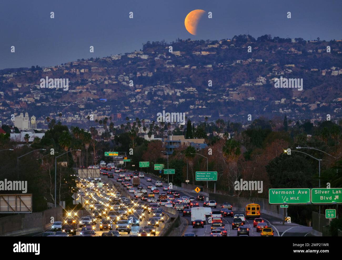 A super blue blood moon is seen setting behind the Hollywood hills in ...