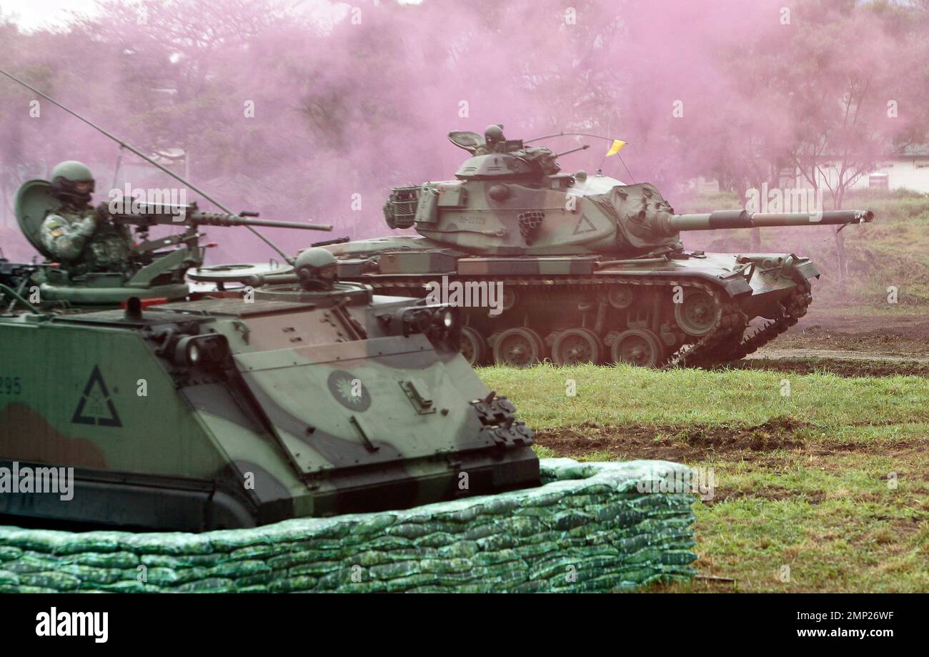 An M60A3 tank, right, passes by an M113 Armored Personnel Carrier ...