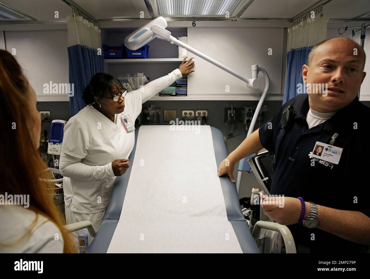 Nurses Tessa Sheffield, from left, Evelyn Fields and Greg Miller look over a mobile emergency