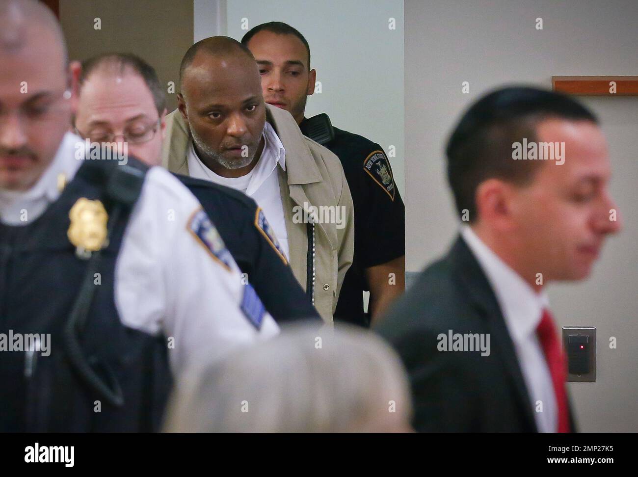 Court officers escort Larry McKee, third center, into court for his  exoneration hearing Monday Jan. 29, 2018, at Bronx Supreme Court in New  York. Judge Robert Torres vacated his murder conviction and