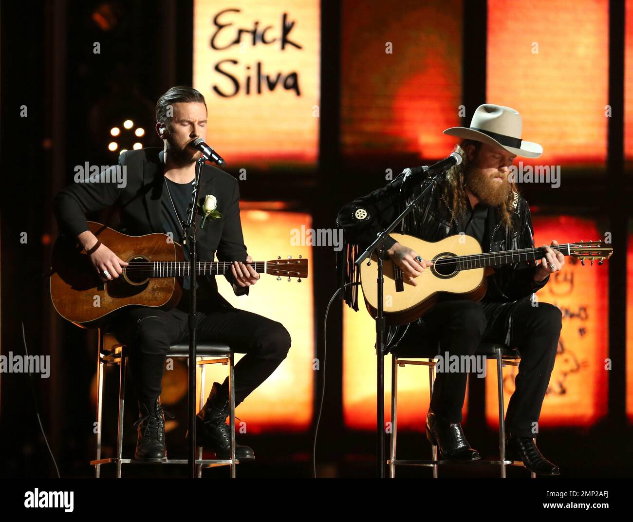 The Brothers Osborne perform as names of victims of tragedies appear onscreen at the 60th annual