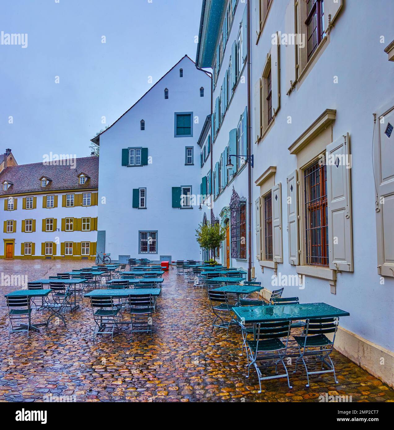 Basel Square Empty cafe on Munsterplatz (Minster Cathedral square) on a rainy day ...