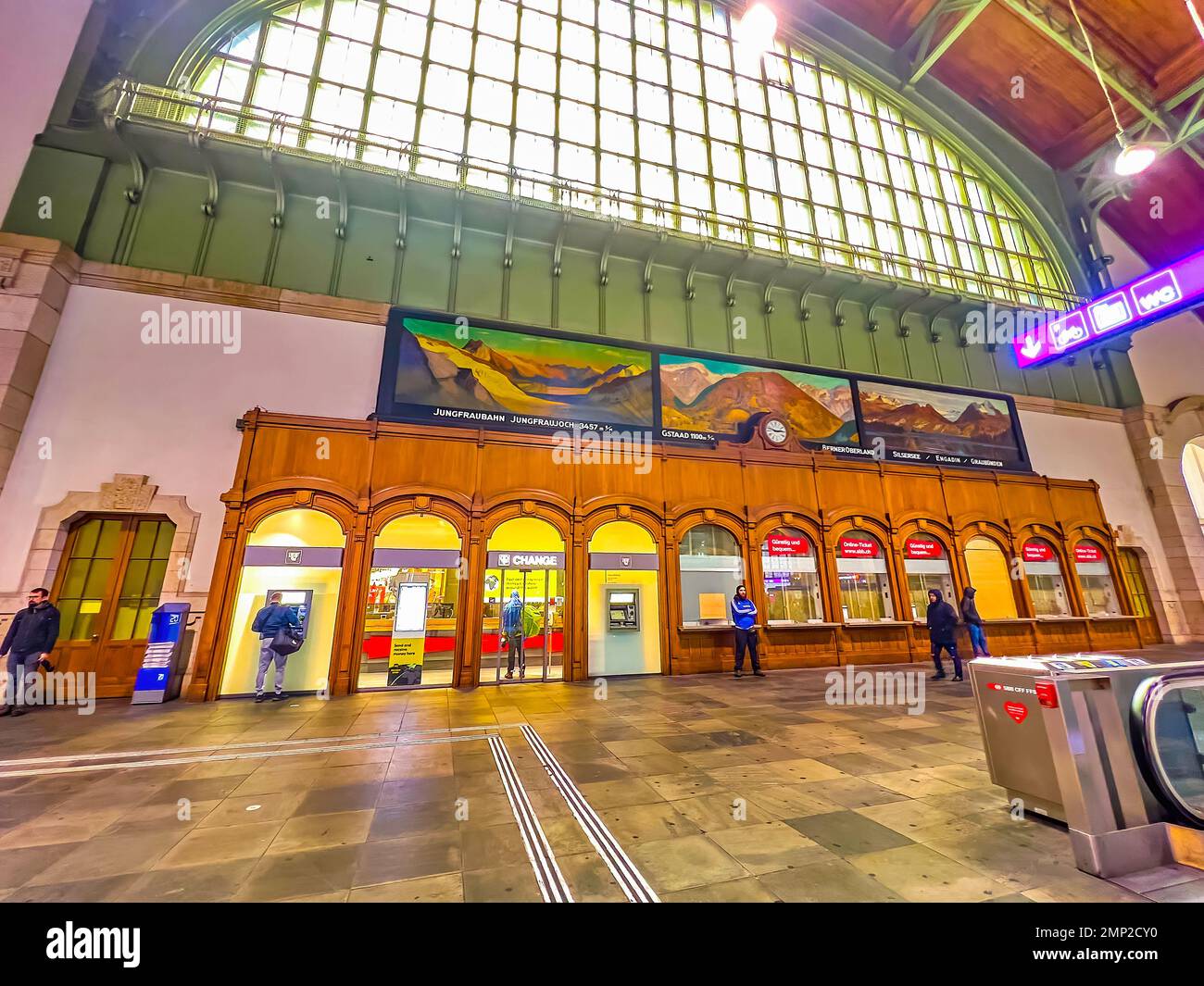 BASEL, SWITZERLAND - APRIL 1, 2022: The interior of Basel SBB railway station with large window and paintings on the wall, on April 1 in Basel, Switze Stock Photo