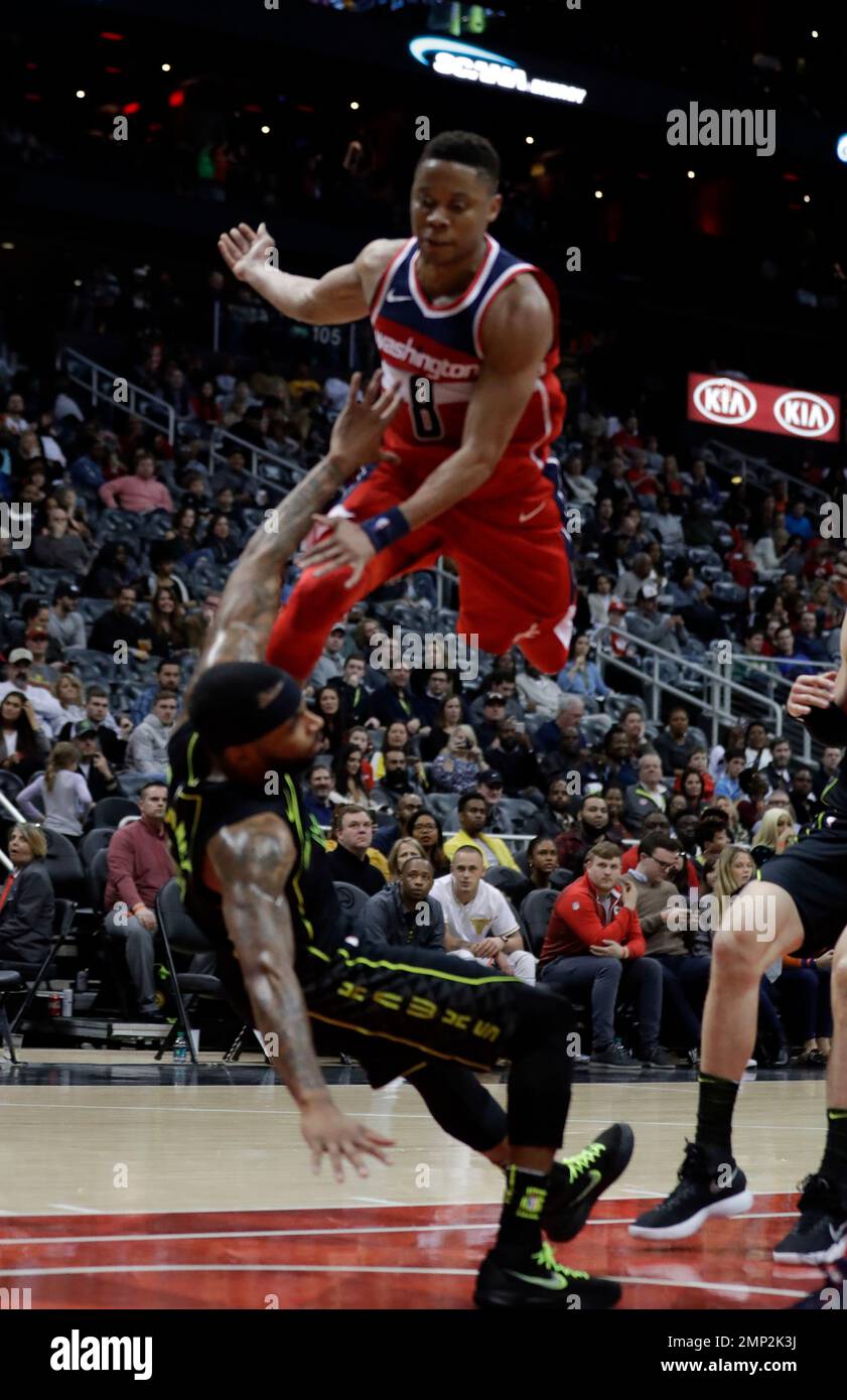 Washington Wizards guard Tim Frazier (8) collides with Atlanta Hawks guard Malcolm Delaney (5) as he goes up for a shot in the second half of an NBA basketball game Saturday, Jan. 27, 2018, in Atlanta. Washington won 129-104 (AP Photo/John Bazemore) Stock Photo