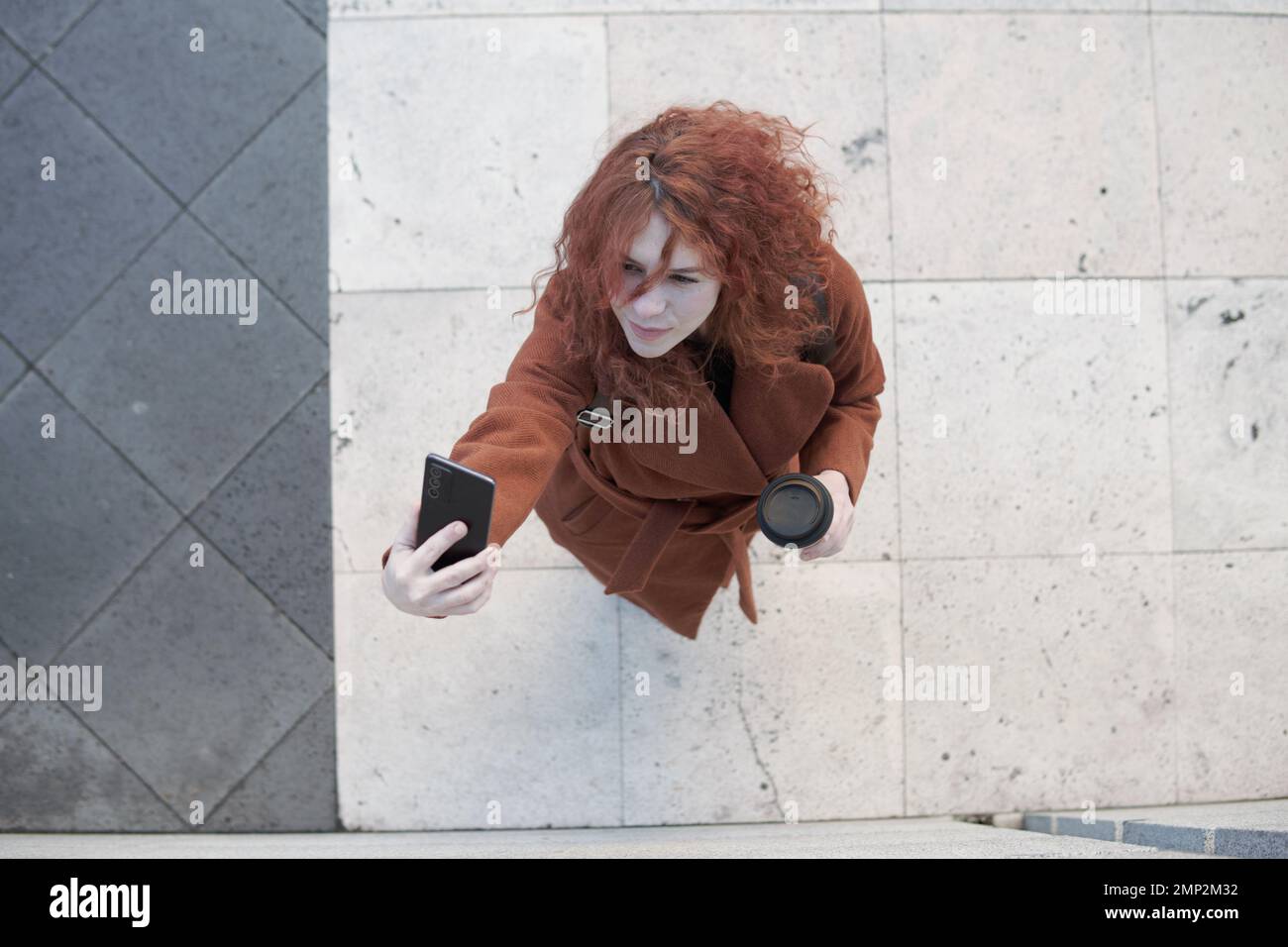 Woman seen from above taking a selfie Stock Photo