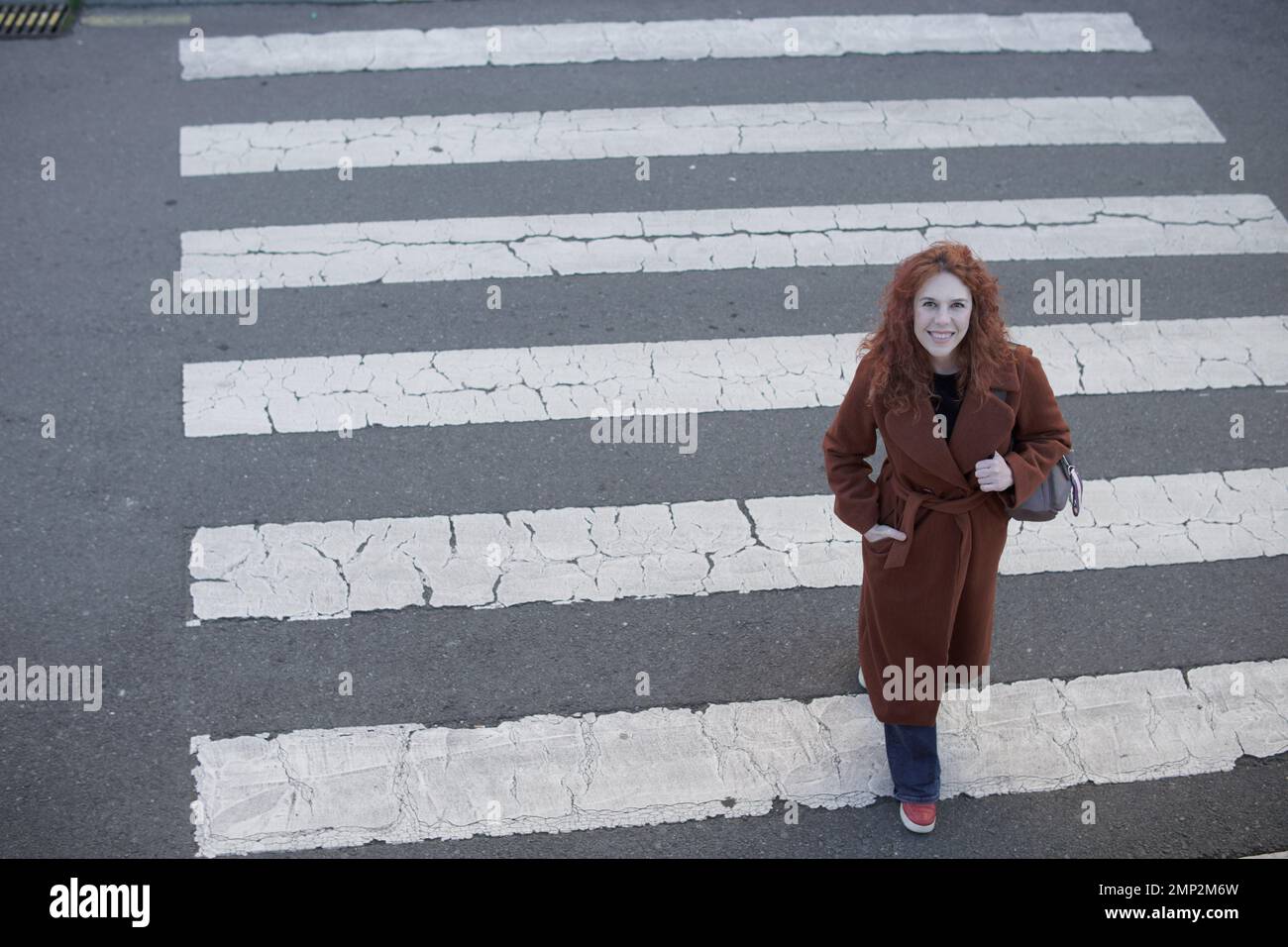 Woman seen from crossing the crosswalk Stock Photo