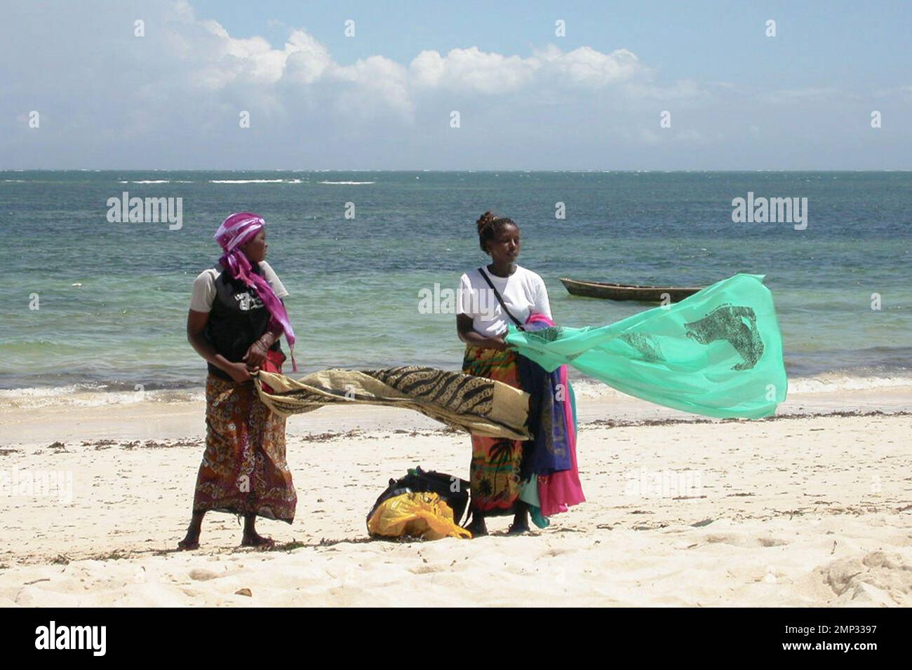 Kenyan women selling sarongs on the beach Stock Photo