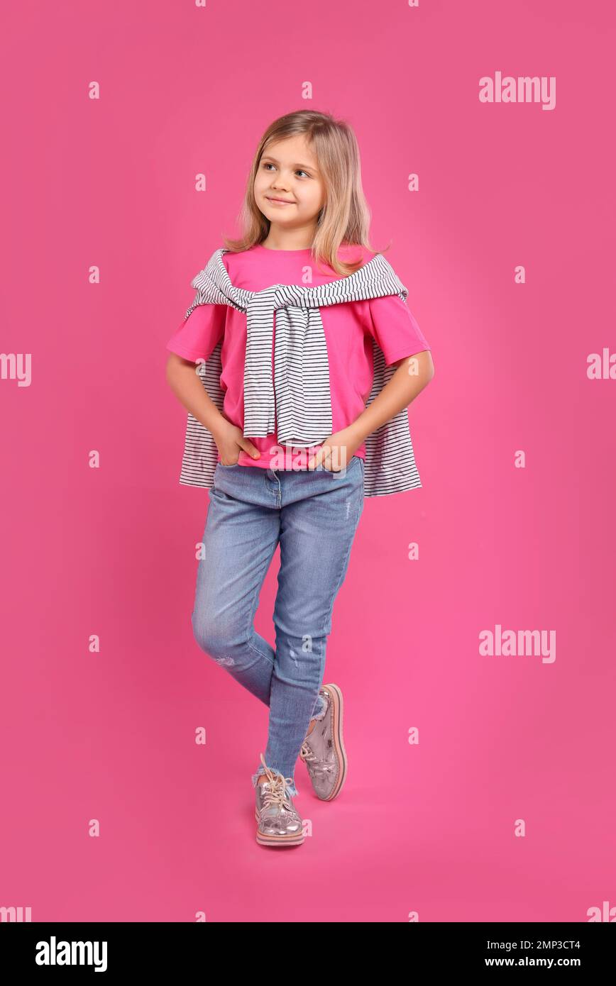 Cute little girl posing on pink background Stock Photo - Alamy