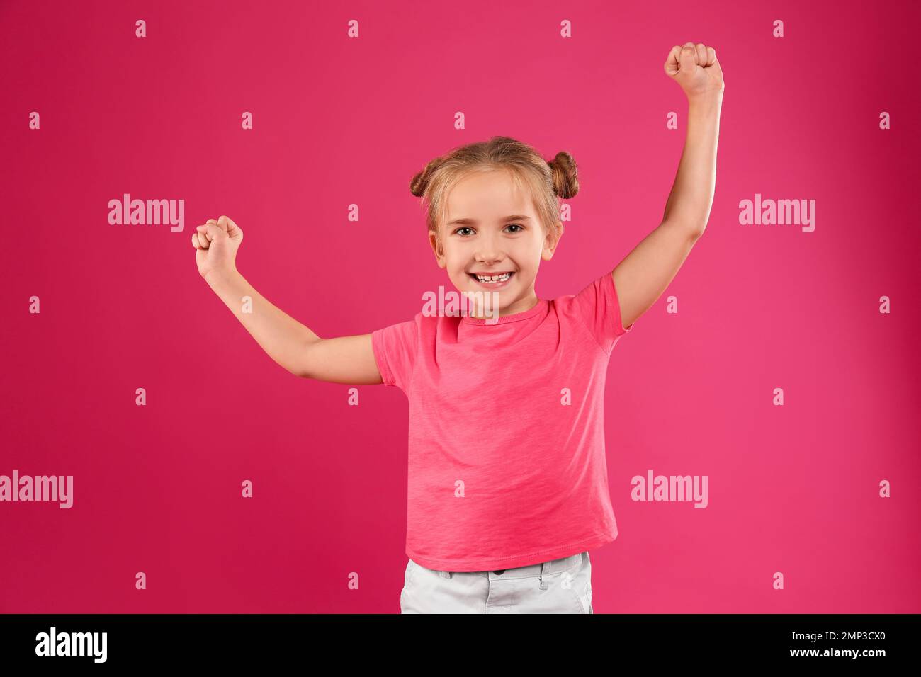 Cute little girl posing on pink background Stock Photo - Alamy