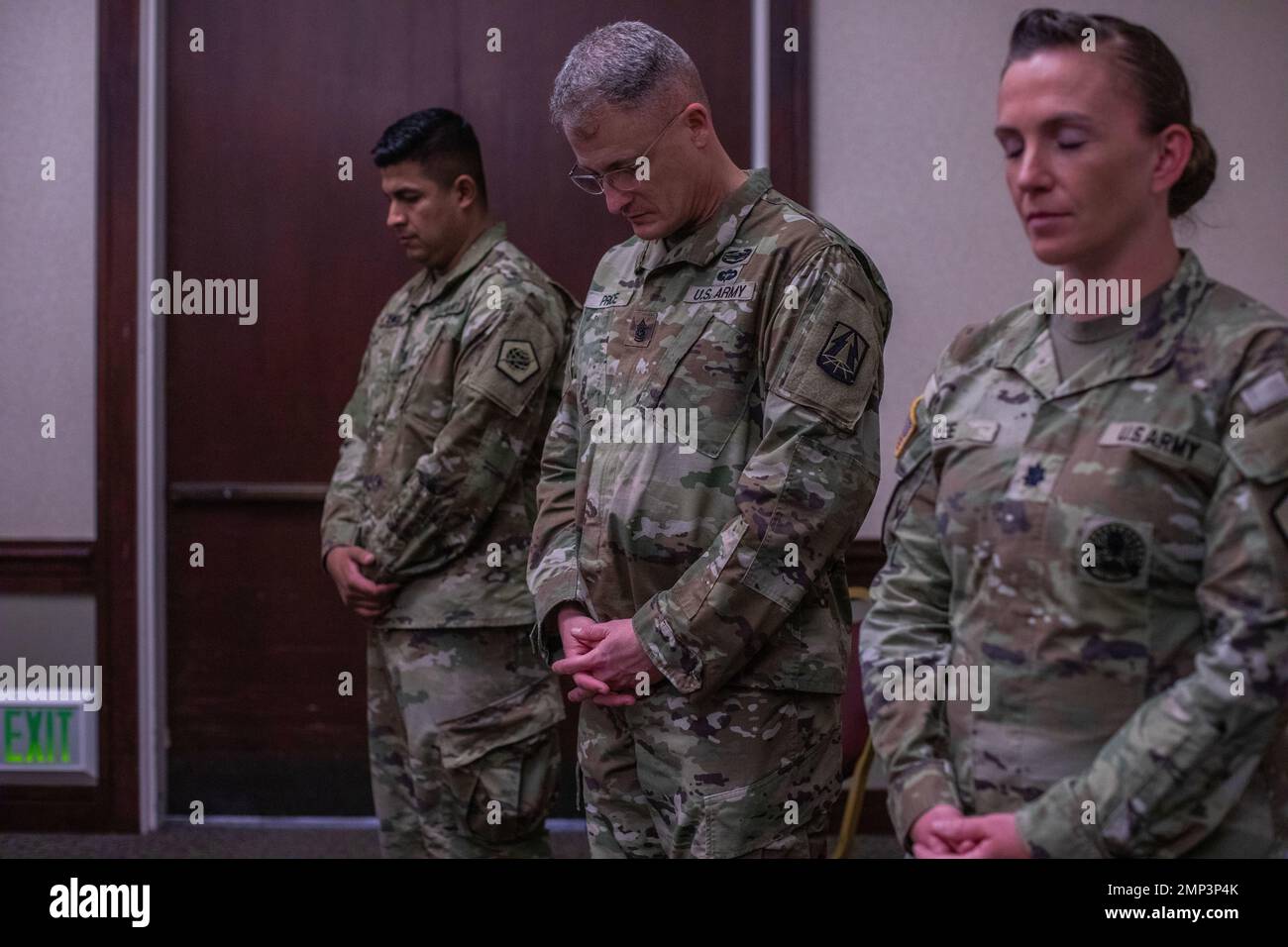 Soldiers bow their heads as an invocation is given on Travis Air Force Base, Fairfield, CA on Sep 10, 2022. The Soldiers prepare to deploy to the CENTCOM area of operations. Stock Photo