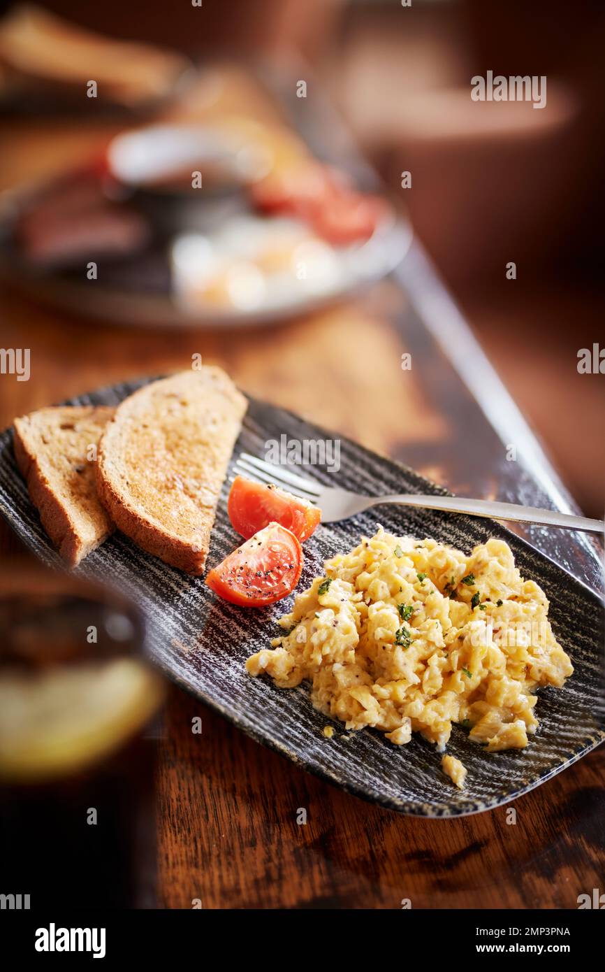 Breakfast fry up brunch gastro pub full english beans bap tomato black pudding potato hash brown scrambled egg bacon tasty food meal classic Stock Photo